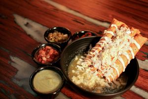 Fried Tacos in hot green sauce. 4 different fillings: Oyster Mushrooms, "Chicken" made from Bamboo fiber, Beans, and Potato with chorizo. at Verde Y Rojo in Tijuana