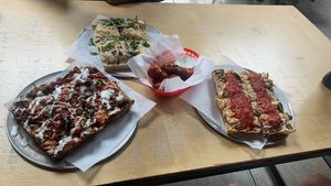 left to right: bbq bacon, ranch, jalapeño cheeseburger pizza.  bianca.  buffalo wings.    at Boxcar Pizza in Portland