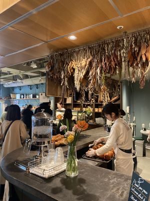 You can see the food being prepared in the kitchen .  at Morethan Bakery in Tokyo
