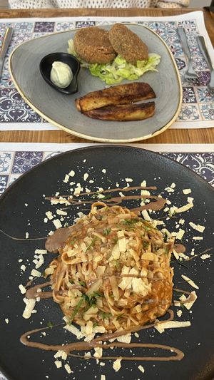 Tagliatelle with hazelnut ragout and porcini mushrooms (bottom). Cordon Bleu of aubergines, smoked cheese, and porcini mushrooms (top).   at Status Quo in Rome