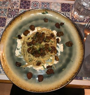 Spaghetti, ricotta di mandorle, melanzane e salsiccia   at Status Quo in Rome