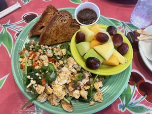 Tofu scramble with a side of fruit bowl and wheat toast.   at Flying Biscuit Cafe in Birmingham