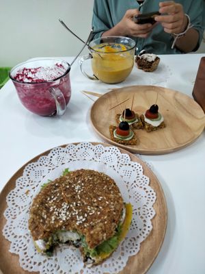 Burger with a bite out of it, beetroot and carrot soups and some tasters at Healthy Mania in Phuket