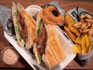 Sándwich de Bistec, ensalada, tostones, onion, platanutres home made! at 100% HP in San Juan