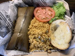 Pastel combo - Puerto Rican version of tamales, made out of plantains and stuffed with beyond meat. Comes with a side of yellow rice and pigeon peas. at 100% HP in San Juan