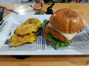 Spicy chikin burger with side of tostones at 100% HP in San Juan