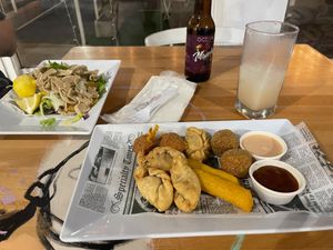 Conch + tostones on the left; HP sample platter at the bottom; soursop juice in the glass at 100% HP in San Juan