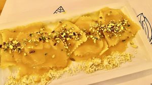 Ravioli ripieni ai ceci con emulsione di olio, limone, cannella e salvia croccante at Nativa in Rome