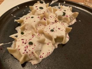 Scrigni: homemade pasta filled with roasted potatoes, chicory, radish leaves, with vegan cacio (cheese) and pepper, sage and currants powder  at Nativa in Rome