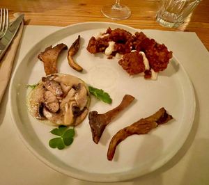 Chickpea tempeh with bourbon, coconut yogurt sauce with lavender and  mustard, apple, mushrooms and wild herbs salad, grilled mushrooms  at Nativa in Rome