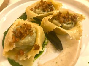 Tortelli filled with black cabbage and vegan mozzarella, crunchy seitan, with cannellini beans and black cabbage creams  at Nativa in Rome