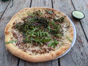 Pizza with dipping sauce at Vegan Pizza Bar in Rotterdam