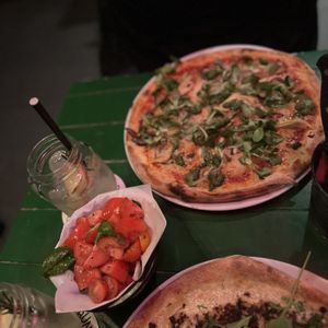 Tomato and basil salad (€5,95) and The Garden (€14,95)  at Vegan Pizza Bar in Rotterdam