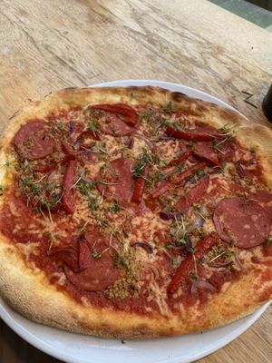 ‘Sala Mommy’ with s*lami, red onion, tomato sauce, homemade cheese, rosemary garlic oil, cress  at Vegan Pizza Bar in Rotterdam