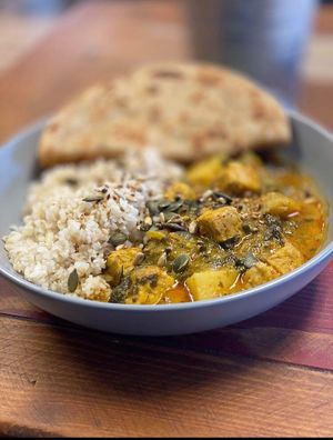 Our favourite curry - Indonesian tempeh, spinach and potato with brown rice, chapati and fresh cilantro  at The V Hub in Swansea