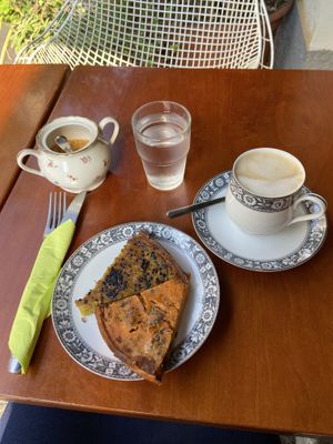 Salty tart/quiche and cappuccino with oat milk  at La Schiscetteria in Milan