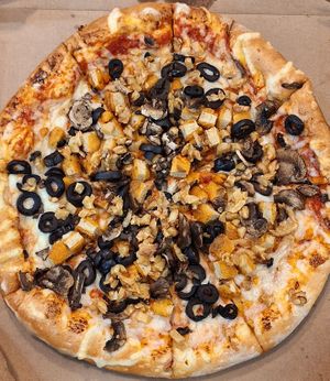 Build your own vegan pizza with chicken, garlic, and olives at Toppers Pizza in Indianapolis