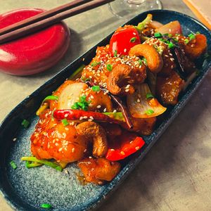 Yuzu Cashew Chicken - Fry Mushroom ‘Chicken’, Cashew Nuts, Onion, Dry Chili, Sesame, Peppers, Sweet & Sour Yuzu Sauce

 at Golden State Vegan Sushi in Bangkok