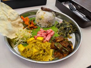 NYONYA BANANA LEAF SET RM25.90
Served with nasi ulam, 3 types of curries, 3 types of vegetables, acar rampai, watermelon raita & kerabu apple
 at Crown Colony Cuisine in Petaling Jaya
