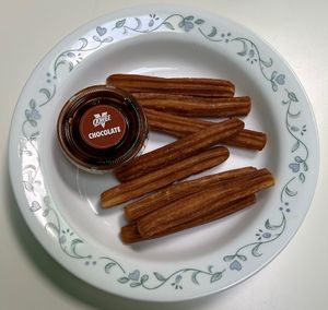 Cinnamon churros with chocolate sauce  at Oowee Vegan in South West London