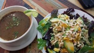Carmo salad and a bowl of green chile soup  at Carmo in New Orleans