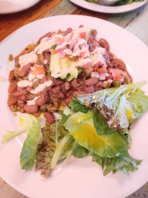 Under the beans and meat is plantains with cheese at Carmo in New Orleans