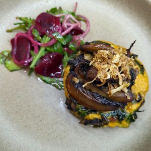 Nelsons Plant based crumpet with garlic mushrooms, mustard custard, basil, garlic and crispy shallots  at Nelsons Wine Bar in Hebden Bridge