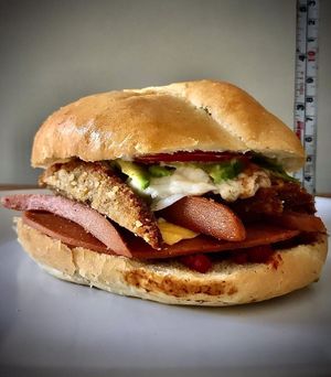 Magnifica torta 100% vegana, rellena de milanesa, salchicha, jamón, chorizo, queso blanco gratinado, frijoles, veganesa, jitomate, aguacate y cebolla.  at Corazon Contento PDC in Playa Del Carmen