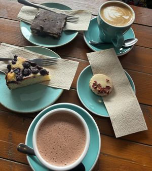 Hot chocolate, latte, tiffin, cardamom & rose shortbread, blueberry & polenta cake.  at Koda Coffee in Scarborough