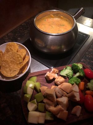 Fiesta-style cheese fondue with bread, fruit, and veggies at The Melting Pot in Oklahoma City