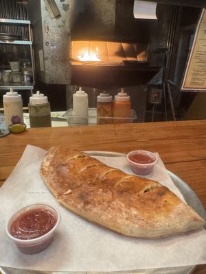 Spinach and mushroom vegan calzone  at Daytona Pizza & Wing Co in Daytona Beach