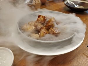 Caramelised Yam Dices with Raw Sugar. Smoke by the sides are from dry ice. at Lotus Vegetarian 莲心 - Novena in Central Singapore