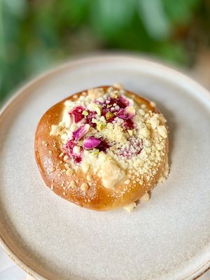 Vegan Bun with Raspberries, Almond Cream, Rose Petals and Pistachios at Eter Vegan Bakery in Warsaw