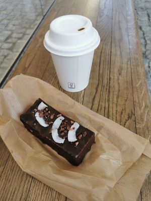 Coconut choco bar and cappuccino at Eter Vegan Bakery in Warsaw