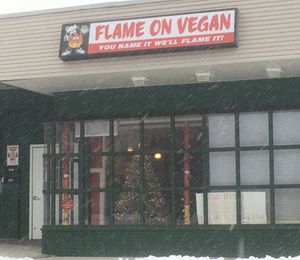 Festive window front in December snow! at Flame On Vegan in Agawam