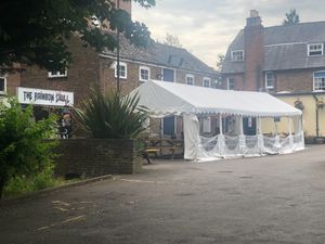 They have loads of covered seating, as well as a green space with more tables to their left and the pub inside to the right. at The Rainbow Skull in Maidstone