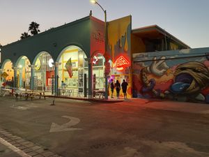 Order at the door under the neon pizza sign    at Love Amaro Pizzeria in Venice