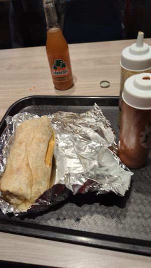 AZ burrito with hot sauces and Jarritos tamarind soda at Tacos Veganos in Phoenix