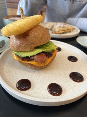 Photo ID: Vegan bacon and egg roll with hash brown and vegan cheese toast is in the background  at Swallow Coffee Traders in Rockdale