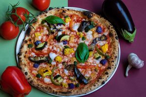 Vegan Pizza Alleria
San Marzano tomato sauce, lentil mozzarella, smoked eggplant, purple cauliflower, roasted bell peppers and zucchini. , spicy almond mozzarella and basil cream at Mastino Pizza in Amsterdam