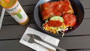 Vegan lasagna with hot tomato paprika sauce, peach rosemary ice tea at KartoffelKonig - Willy-Brandt-Platz in Munich
