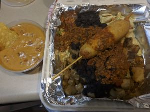 Not the greatest photo, but one of their recent vegan specials (a corn dog garbage plate!!!) and a side of their new vegan queso.  at John's Tex Mex in Rochester