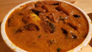 Aloo begun ($13). Acrid/bitter flavor, undercooked potatoes. at Curry In A Hurry in Minneapolis