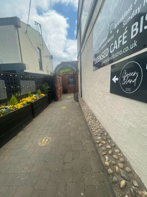 Entrance - tucked away (spot the flowers at the end of the pub on the corner) at Green Island Bistro in Rhuddlan