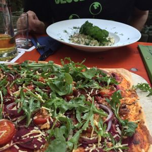 Flammkuchen in the foreground and risotto in the background  at Viasko - Bar und Restaurant in Berlin
