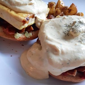 No eggs benny's with white wine hollandaise, roasted tomatoes and coconut bakon  at Nourish 2 Flourish in Edmonton