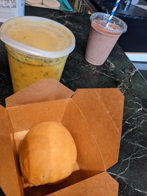 My takeout brunch, hot gr the pot broccoli cheese soup, breakfast egg & sausage kolache with choc-o-lit cookie bomb smoothie. at Sinfull Bakery in Houston