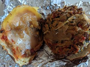 Chef Dylan's delicious smokey bean burger on a pretzel bun, with provolone cheese after being reheated at home. at Sinfull Bakery in Houston