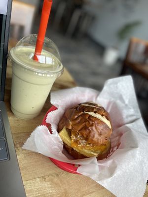 Banana Matcha Smoothie and Pretzel Bun Just Egg with Sausage sandwich   at Sinfull Bakery in Houston