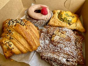 Raspberry cronut, cheese danish, almond croissant, and savory croissant at Le Petit Monstre in Brooklyn